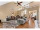 Spacious living room with high ceilings, a cozy sectional sofa, and a beautiful staircase at 1605 Little Lisa Ln, Snellville, GA 30078