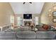 Cozy living room with fireplace, built-in shelving, and a vaulted ceiling creating an inviting space at 1605 Little Lisa Ln, Snellville, GA 30078