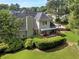 Charming home featuring a spacious deck, manicured lawn, and lush greenery, perfect for outdoor living and entertaining at 1605 Little Lisa Ln, Snellville, GA 30078