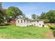 Large backyard with a well-maintained lawn, privacy fence, and an exterior view of the house at 185 Pamela Nw St, Marietta, GA 30064