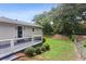 An inviting deck overlooks the partially fenced backyard with lush lawn and mature trees at 185 Pamela Nw St, Marietta, GA 30064