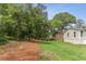 Backyard featuring an exterior view of the house, privacy fence, trees, and a well-maintained lawn at 185 Pamela Nw St, Marietta, GA 30064