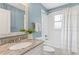 Bathroom featuring a granite countertop, mirror, tub, shower, and white tile at 185 Pamela Nw St, Marietta, GA 30064