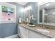 Bright bathroom with granite countertops, double vanity, and light fixtures at 185 Pamela Nw St, Marietta, GA 30064