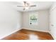 Bedroom with hardwood floors, a ceiling fan, a closet, and a window looking out onto the front yard at 185 Pamela Nw St, Marietta, GA 30064