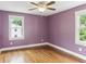 Bedroom with hardwood floors, a ceiling fan, and two windows looking out onto the back yard at 185 Pamela Nw St, Marietta, GA 30064