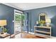 Bright entryway with hardwood floors, stylish console table and a modern glass door leading to the front porch at 185 Pamela Nw St, Marietta, GA 30064