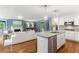 The open-concept kitchen features an island with granite countertops and seating overlooking the living area at 185 Pamela Nw St, Marietta, GA 30064