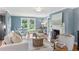 Open-concept living room features a fireplace and large windows at 185 Pamela Nw St, Marietta, GA 30064