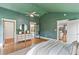 Spacious main bedroom featuring wood floors, a ceiling fan, and ensuite bathroom access at 185 Pamela Nw St, Marietta, GA 30064