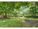 Wide backyard showing the property line and shade trees at 1850 Francis Sw Rd, Conyers, GA 30094