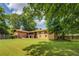 Sprawling backyard features established trees and the back exterior of the home at 1850 Francis Sw Rd, Conyers, GA 30094