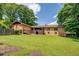 Large backyard showcasing the home's back exterior, screened porch and ramp at 1850 Francis Sw Rd, Conyers, GA 30094