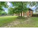 Back of house is visible from the expansive backyard with mature trees at 1850 Francis Sw Rd, Conyers, GA 30094