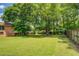 Beautiful backyard features mature trees and a well-maintained lawn at 1850 Francis Sw Rd, Conyers, GA 30094