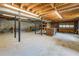 Unfinished basement with exposed wood ceilings and cinder block walls, offering potential for customization at 1850 Francis Sw Rd, Conyers, GA 30094