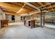 Unfinished basement with concrete floor and exposed pipes and beams at 1850 Francis Sw Rd, Conyers, GA 30094
