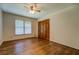 An airy bedroom features hardwood floors, a window, and closet doors for added storage at 1850 Francis Sw Rd, Conyers, GA 30094