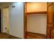 This is a walk-in closet with upper wooden rails for hanging clothes and hardwood floor at 1850 Francis Sw Rd, Conyers, GA 30094