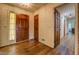 Inviting foyer with hardwood floors, detailed wallpaper and a solid wood front door at 1850 Francis Sw Rd, Conyers, GA 30094