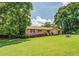 Well-manicured lawn accentuates this quaint single story home with brick and stone exterior with mature trees at 1850 Francis Sw Rd, Conyers, GA 30094