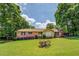 Charming brick home with lush green lawn, beautiful landscaping, and inviting curb appeal at 1850 Francis Sw Rd, Conyers, GA 30094