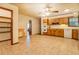 Tile floored kitchen with wood cabinets and white appliances opens to an unfinished space at 1850 Francis Sw Rd, Conyers, GA 30094