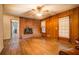 Living room with a brick fireplace, wood-paneled walls, hardwood floors, and natural light at 1850 Francis Sw Rd, Conyers, GA 30094