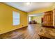 Cozy living room with yellow walls and wood flooring, features an open layout at 1850 Francis Sw Rd, Conyers, GA 30094