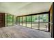 Spacious sunroom features wooden flooring and walls of screens showcasing backyard at 1850 Francis Sw Rd, Conyers, GA 30094