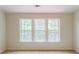 Bedroom with a large window and natural light and neutral carpet at 3990 Howell Park Rd, Duluth, GA 30096