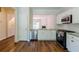 Open kitchen with stainless steel appliances, granite countertops, and a view into the living space at 3990 Howell Park Rd, Duluth, GA 30096