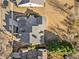 Overhead view of an upscale home with a complex roof, and a well manicured lawn with mature landscaping and trees at 487 Carmichael Cir, Canton, GA 30115