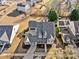 Aerial view of a home showcasing its roofline, landscaping, driveway, and neighborhood context on a sunny day at 487 Carmichael Cir, Canton, GA 30115