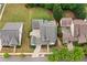Bird's eye view of a home with lush lawn and mature trees showcasing its roofline, landscaping, and neighborhood on a sunny day at 487 Carmichael Cir, Canton, GA 30115