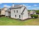 Lush backyard showing light gray siding and large green backyard with a driveway and detached garage at 487 Carmichael Cir, Canton, GA 30115