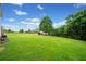 Expansive backyard features lush green grass and mature trees offering a private outdoor space at 487 Carmichael Cir, Canton, GA 30115