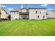 Expansive backyard features a lush lawn, patio, and the rear view of a house with light gray siding at 487 Carmichael Cir, Canton, GA 30115