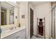 Clean bathroom featuring a vanity, large mirror, and shower with a glass door at 487 Carmichael Cir, Canton, GA 30115