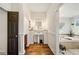 Bathroom featuring a pedestal sink, hardwood floors, and access to a soaking tub at 487 Carmichael Cir, Canton, GA 30115