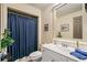 Bright bathroom with white vanity, mirror, and shower with blue curtain at 487 Carmichael Cir, Canton, GA 30115