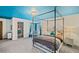 Stylish bedroom featuring a canopy bed, blue accents, and a spacious walk-in closet at 487 Carmichael Cir, Canton, GA 30115