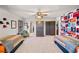 Spacious bedroom with colorful decor, a ceiling fan, and two twin beds at 487 Carmichael Cir, Canton, GA 30115