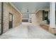 Covered breezeway connects the main house to the garage with brick walls and concrete flooring at 487 Carmichael Cir, Canton, GA 30115