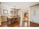 Inviting dining room with warm wood floors, traditional chandelier, and access to the staircase at 487 Carmichael Cir, Canton, GA 30115