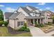 Attractive brick home with a covered porch, manicured shrubs, and a driveway leading to the garage at 487 Carmichael Cir, Canton, GA 30115