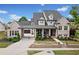 Beautiful brick home featuring manicured landscaping, a covered porch, and a driveway leading to the garage at 487 Carmichael Cir, Canton, GA 30115