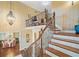 Grand foyer featuring hardwood floors, a winding staircase, and a view of the dining room at 487 Carmichael Cir, Canton, GA 30115