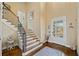 Inviting foyer features hardwood floors, staircase, and a glass-paneled front door, creating a warm welcome at 487 Carmichael Cir, Canton, GA 30115