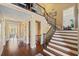 Grand foyer with a winding staircase, hardwood floors, and ample natural light at 487 Carmichael Cir, Canton, GA 30115